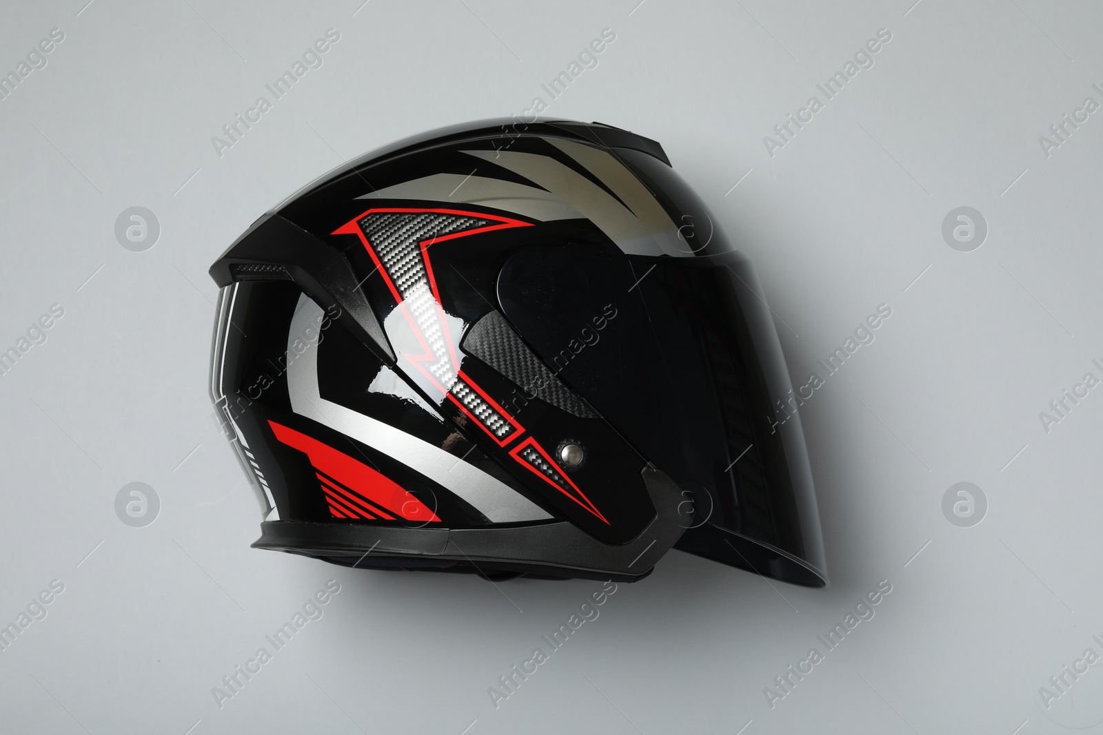 Photo of Modern motorcycle helmet with visor on gray background, top view