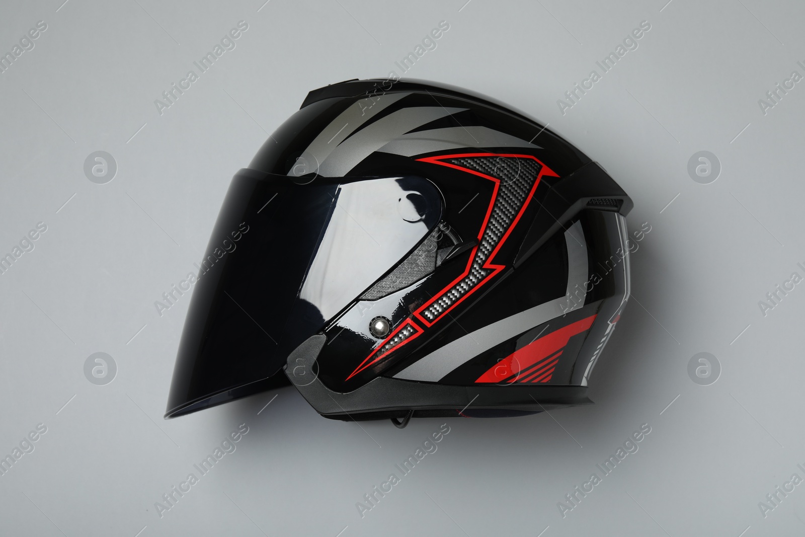 Photo of Modern motorcycle helmet with visor on gray background, top view