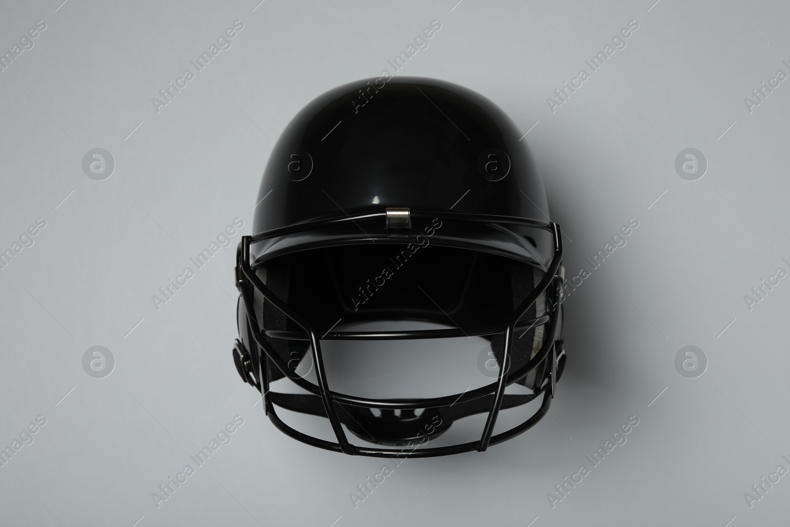 Photo of Black baseball helmet on gray background, top view