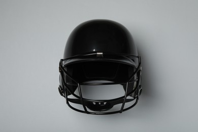 Black baseball helmet on gray background, top view