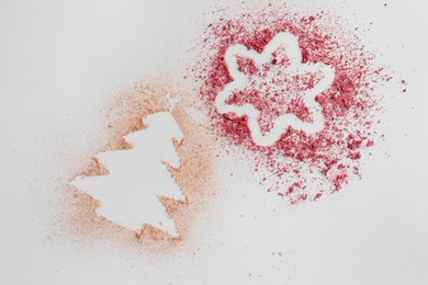 Christmas tree and star made of powder and blush on white background, top view