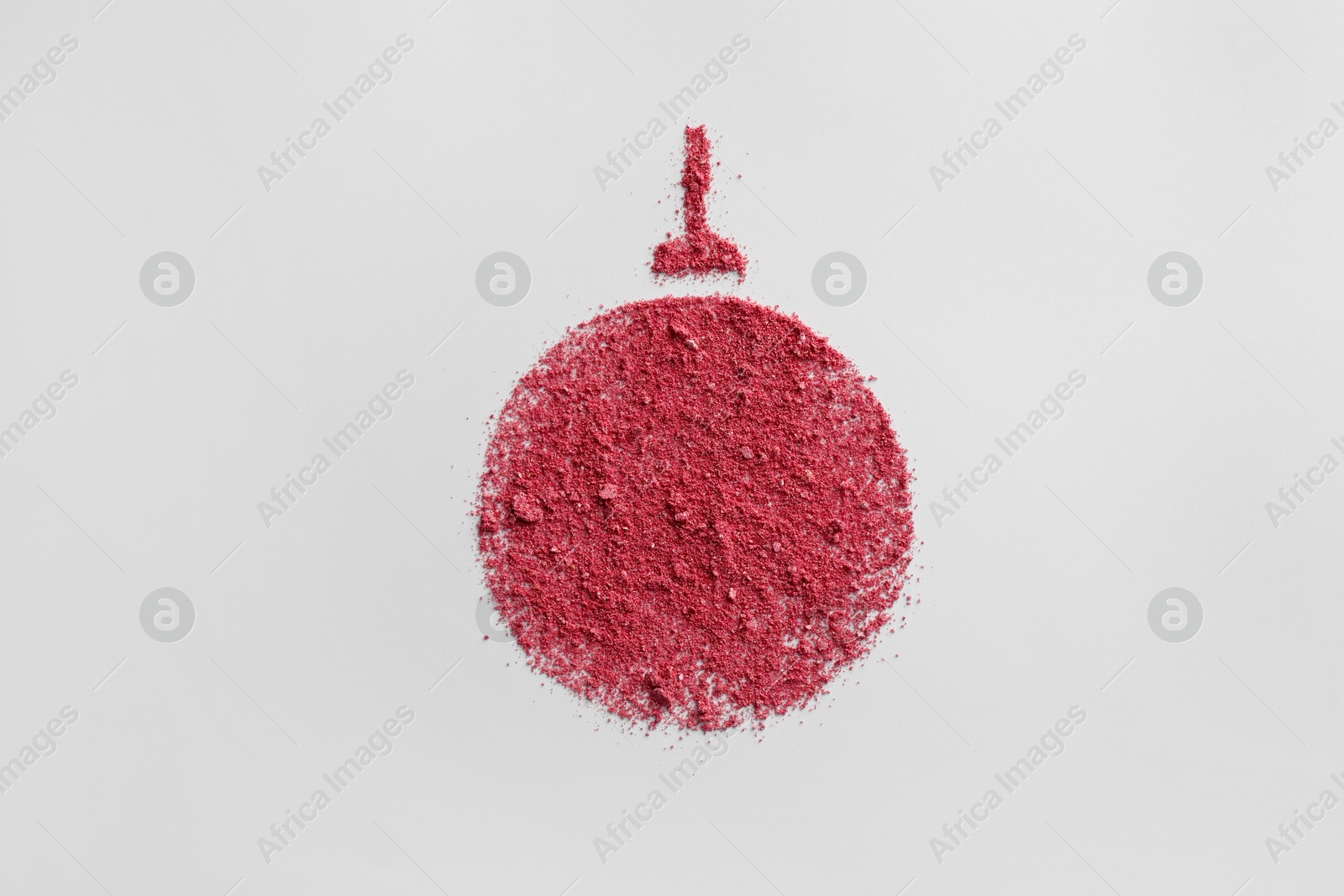 Photo of Christmas ball made of blush on white background, top view