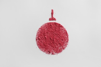 Photo of Christmas ball made of blush on white background, top view