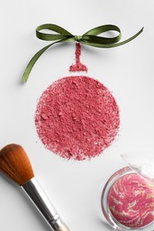 Photo of Christmas ball made of blush with bow and makeup brush on white background, flat lay