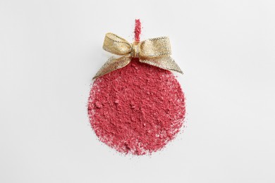 Photo of Christmas ball made of blush with bow on white background, top view