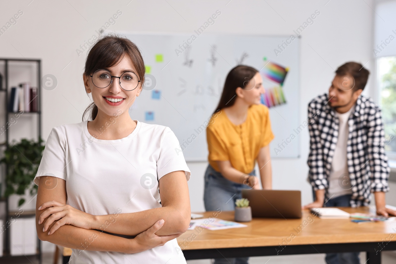 Photo of Happy young designer with glasses in office