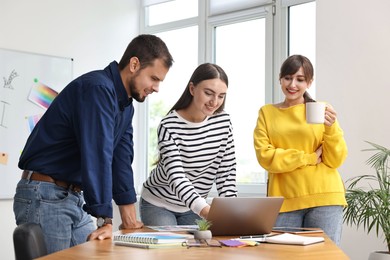 Photo of Group of designers working together in office