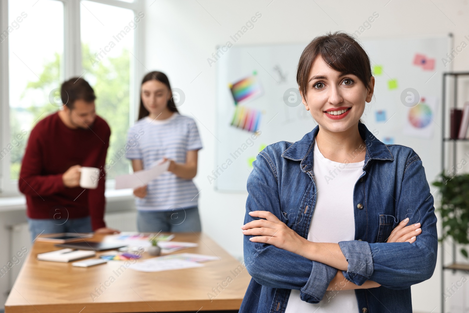 Photo of Portrait of happy young designer in office