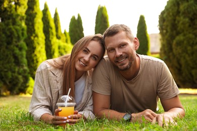 Photo of Couple spending time together on green lawn in park