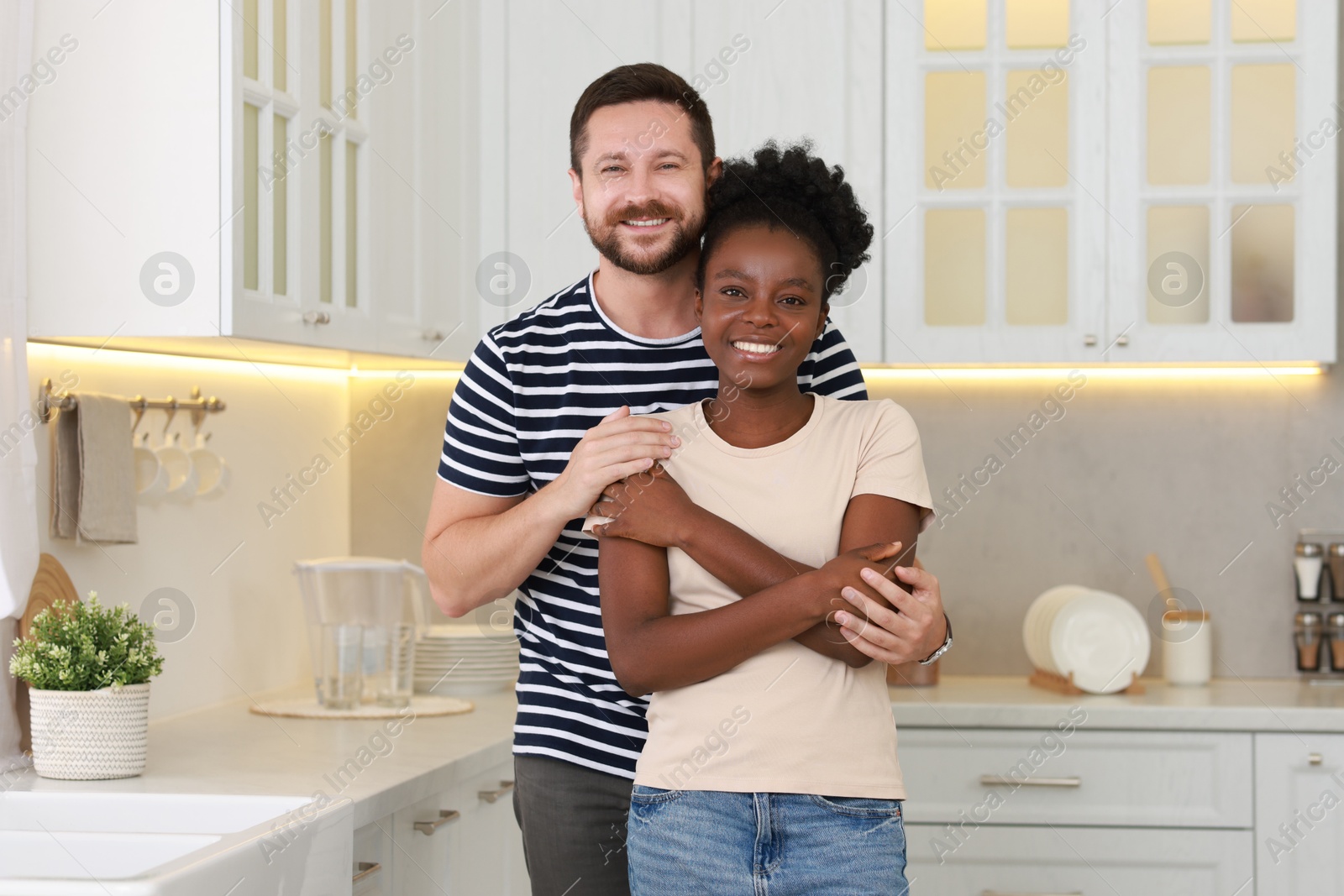 Photo of International relationships. Portrait of lovely couple in kitchen