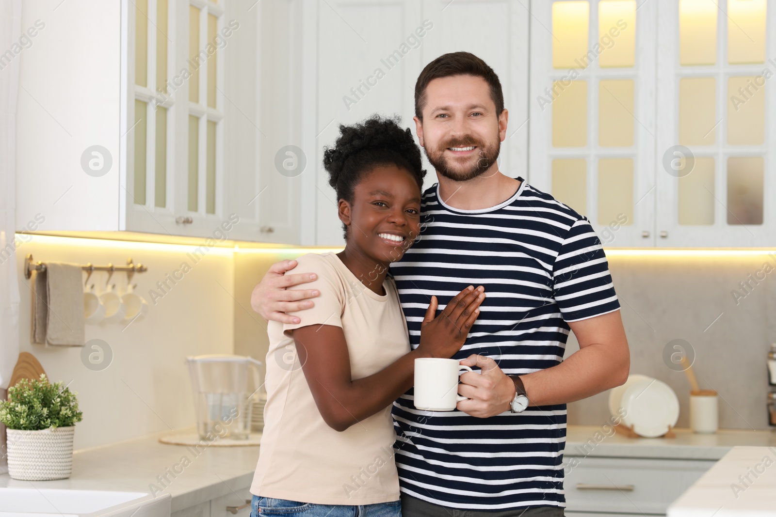 Photo of International relationships. Portrait of lovely couple in kitchen