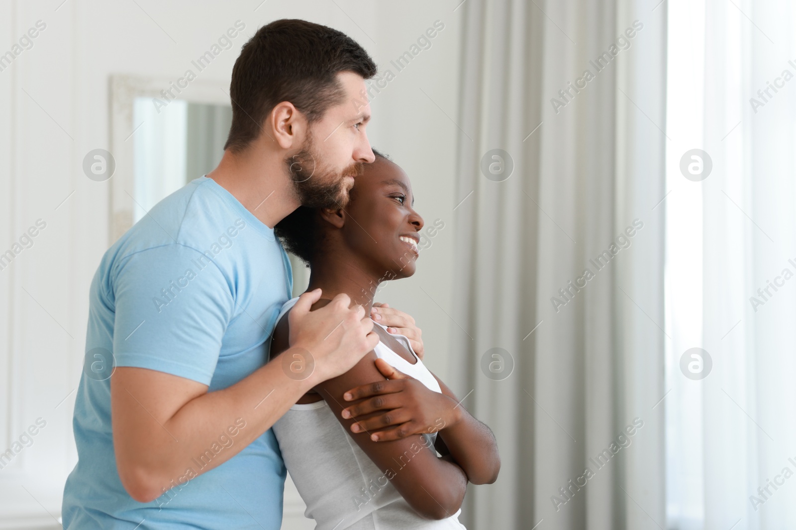 Photo of International relationships. Portrait of lovely couple at home, space for text