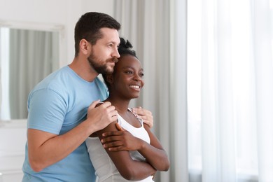 Photo of International relationships. Portrait of lovely couple at home, space for text