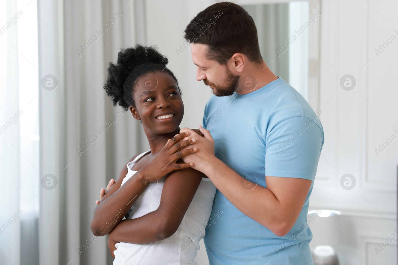 Photo of International relationships. Portrait of lovely couple at home