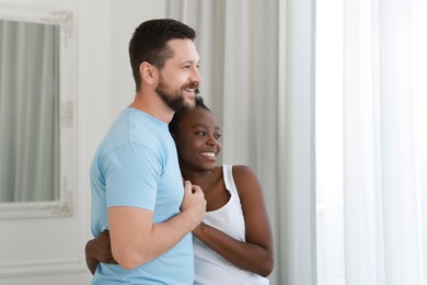 Photo of International relationships. Portrait of lovely couple at home, space for text