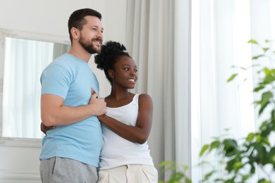 Photo of International relationships. Portrait of lovely couple at home, space for text