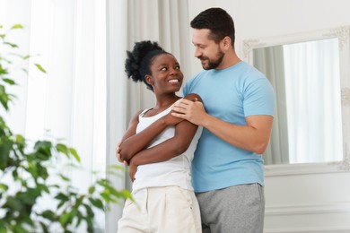 International relationships. Portrait of lovely couple at home