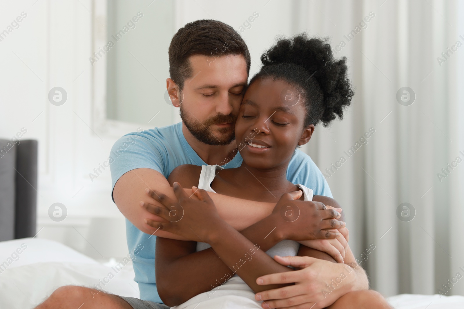 Photo of International relationships. Portrait of lovely couple at home