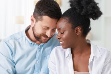 International relationships. Portrait of lovely couple at home