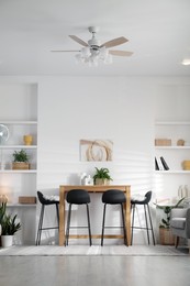 Bar stools near table in room. Interior design