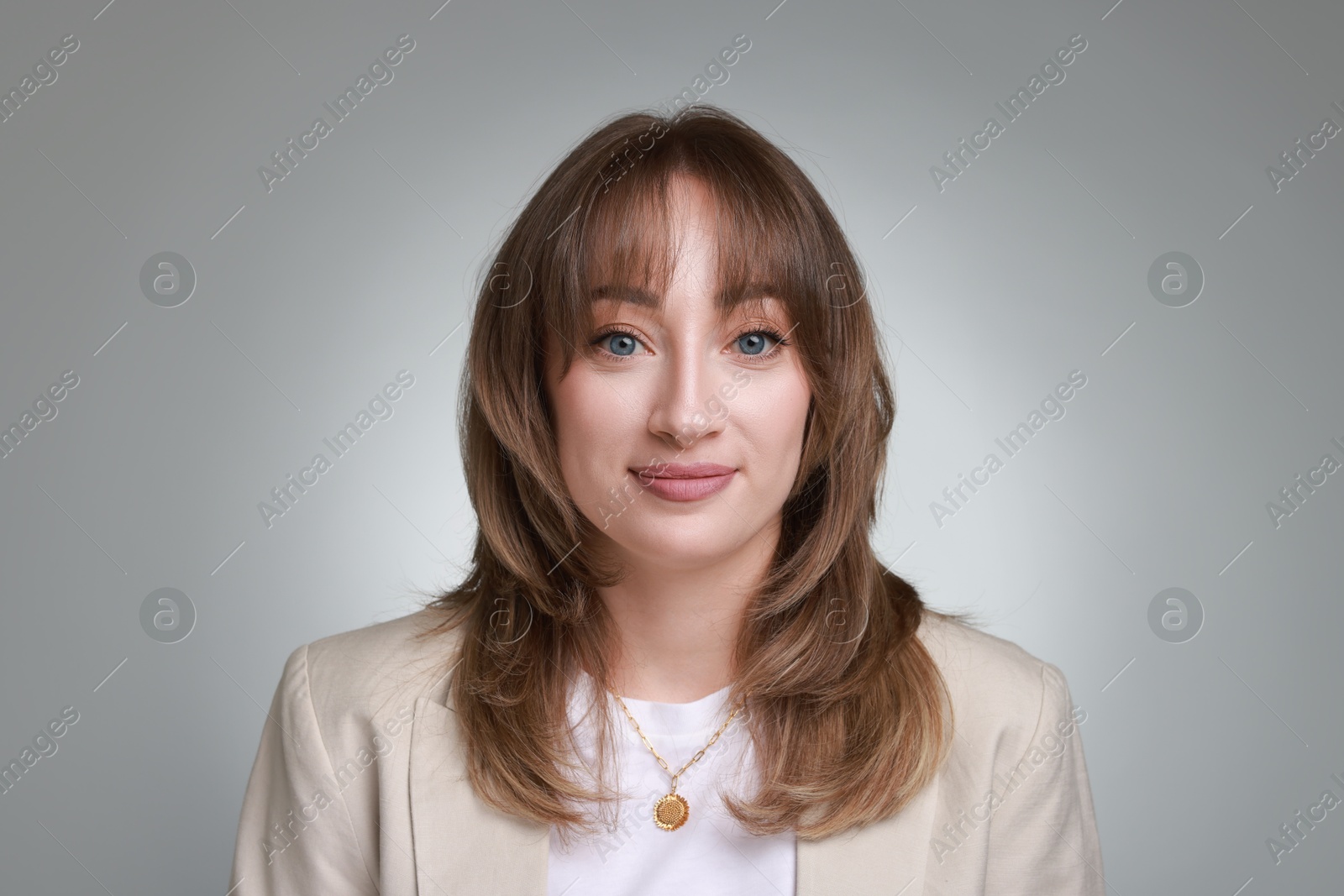 Photo of Attractive woman with stylish haircut on grey gradient background