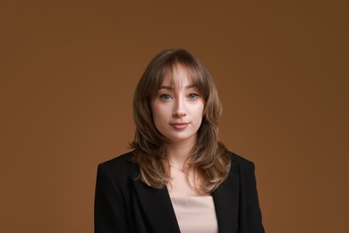 Photo of Attractive woman with stylish haircut on brown background