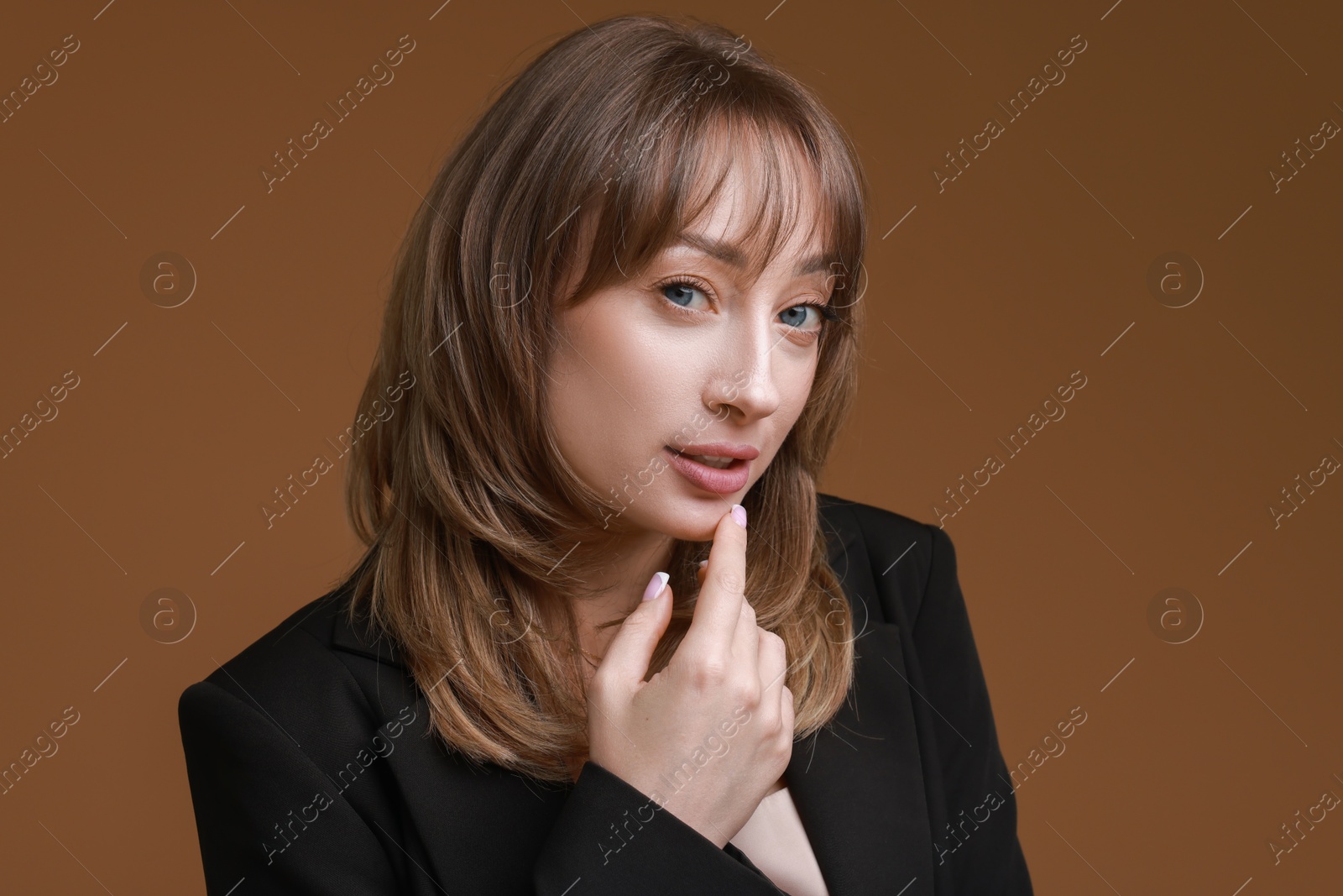 Photo of Attractive woman with stylish haircut on brown background