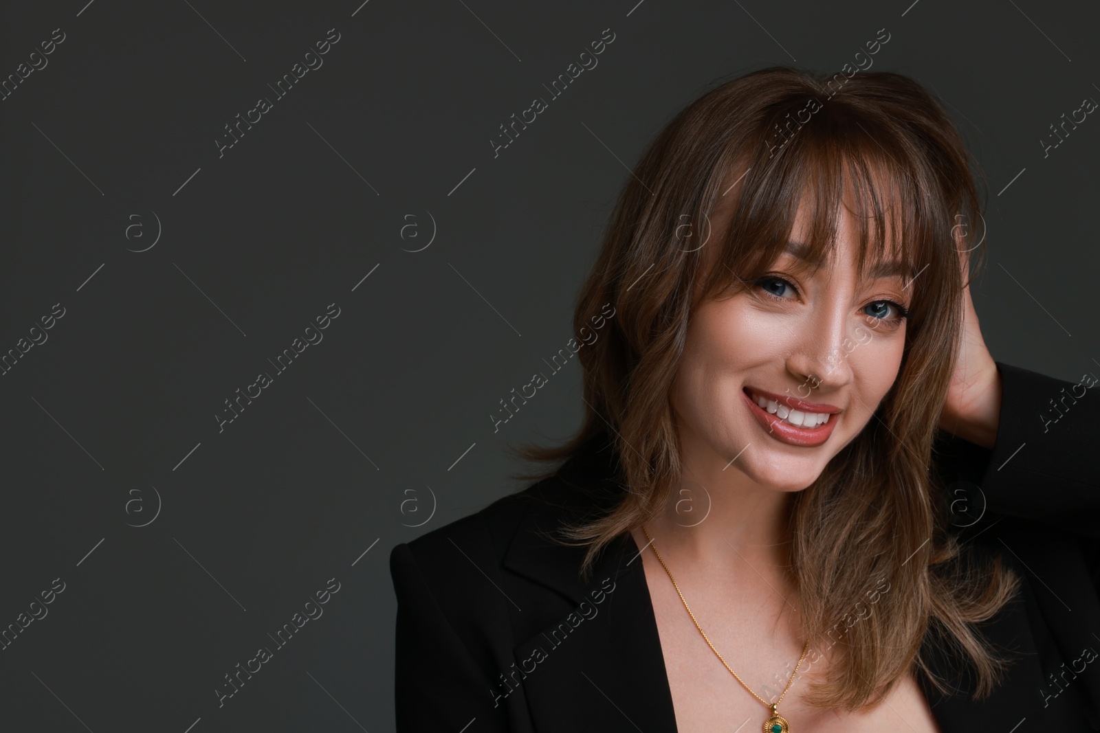 Photo of Attractive woman with stylish haircut on grey background, space for text