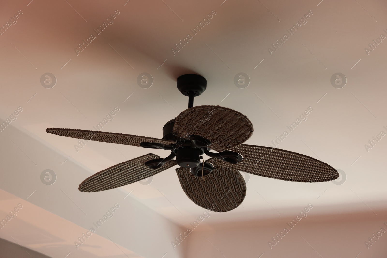 Photo of Modern ceiling fan indoors, low angle view