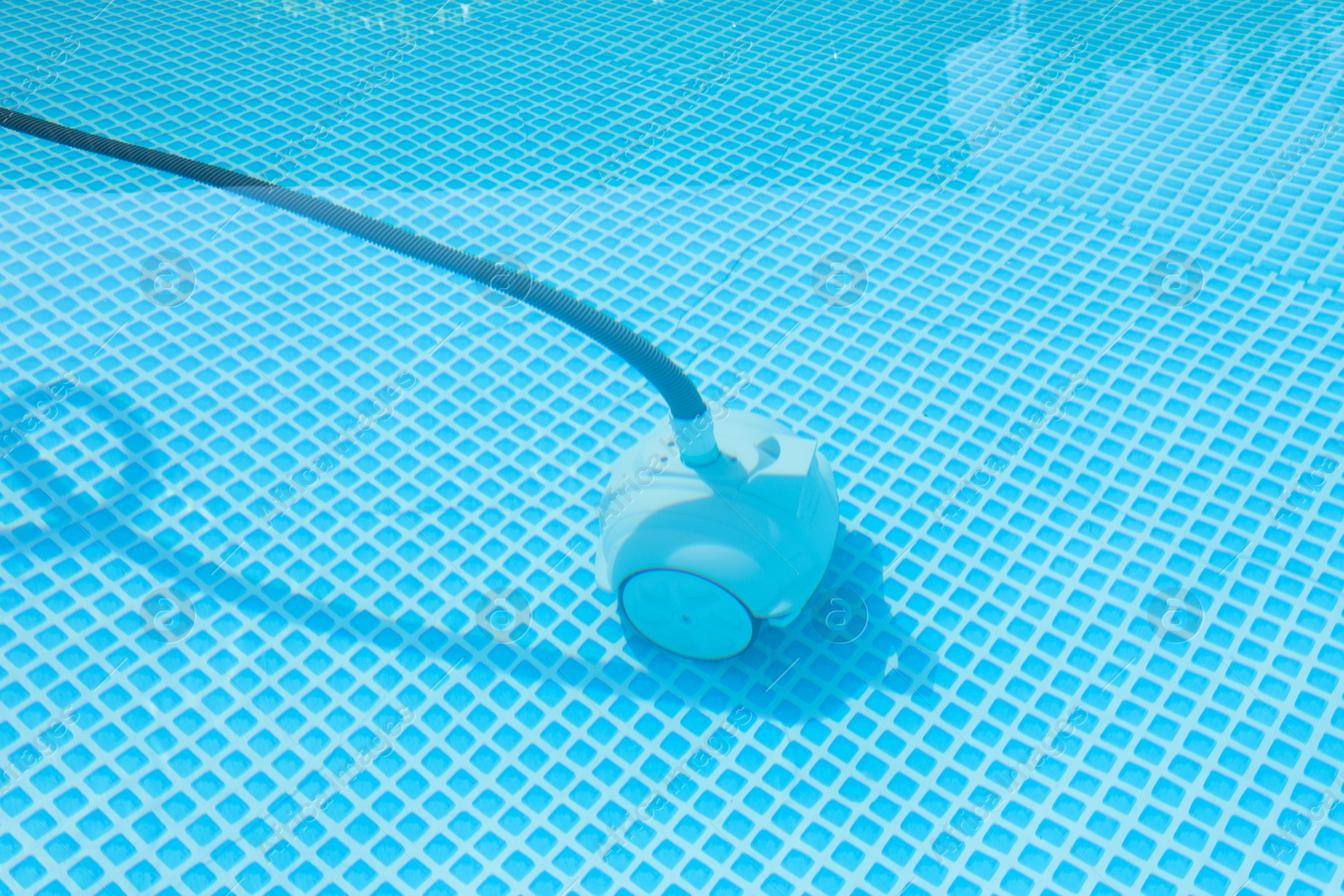 Photo of One robotic cleaner in swimming pool outdoors