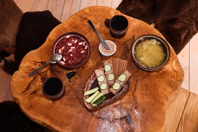 Different dishes of Ukrainian cuisine on wooden table in cafe, flat lay