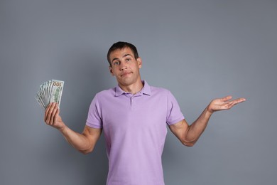 Man with dollar banknotes on grey background