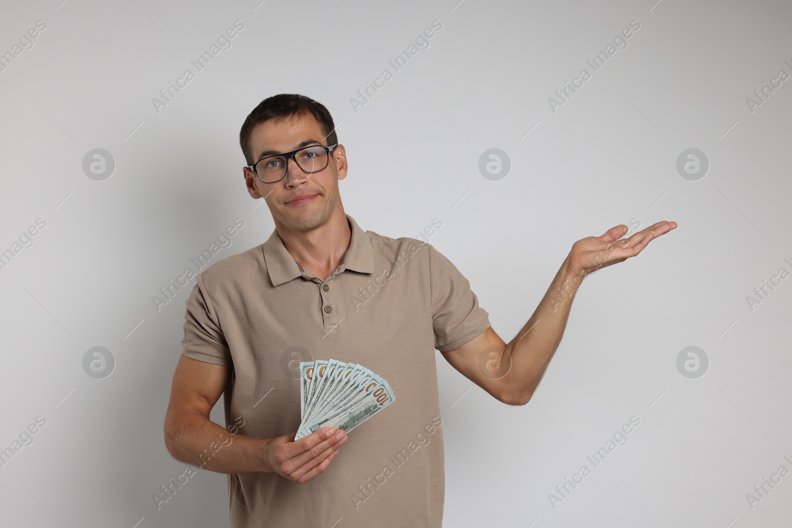 Photo of Man with dollar banknotes on white background