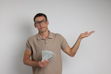 Man with dollar banknotes on white background