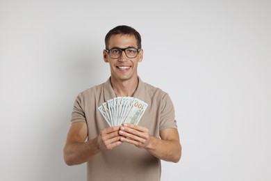 Man with dollar banknotes on white background