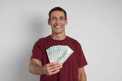 Happy man with money on white background