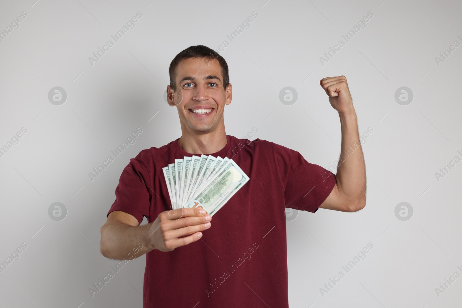 Photo of Happy man with money on white background