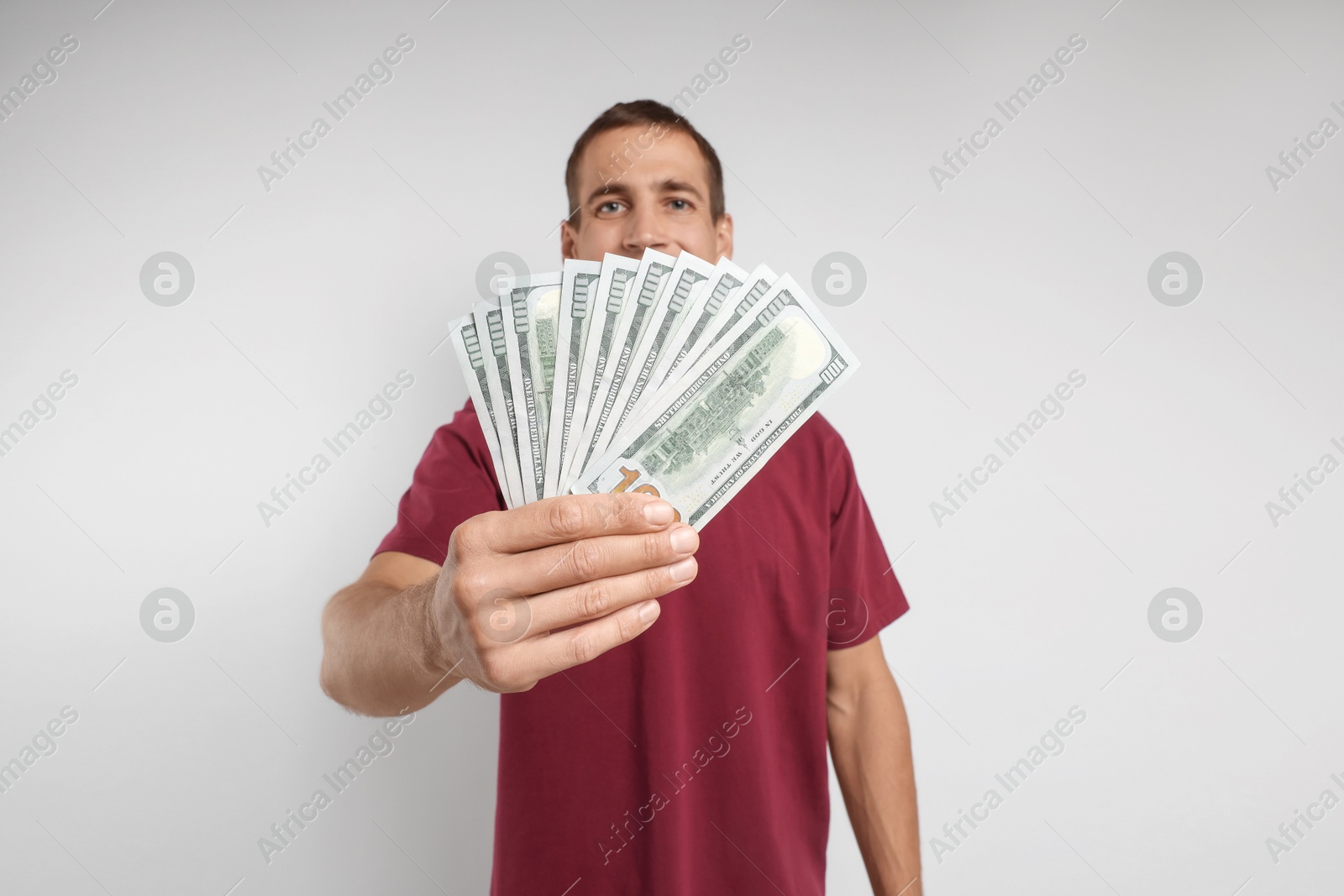 Photo of Man with dollar banknotes on white background, selective focus