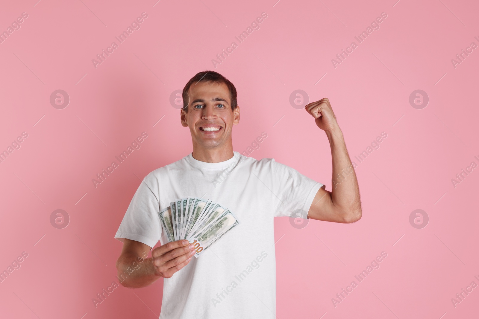 Photo of Happy man with money on pink background