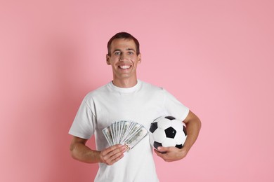 Photo of Happy man with money and soccer ball on pink background