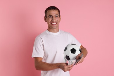 Photo of Happy man with money and soccer ball on pink background