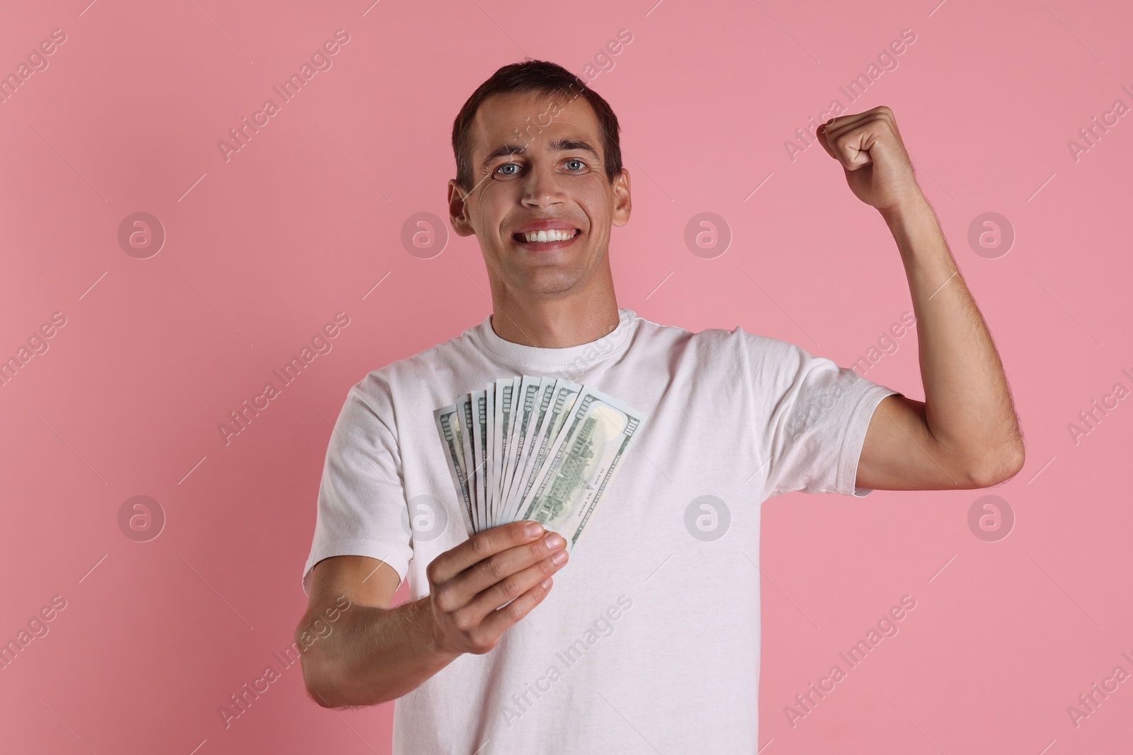 Photo of Happy man with money on pink background