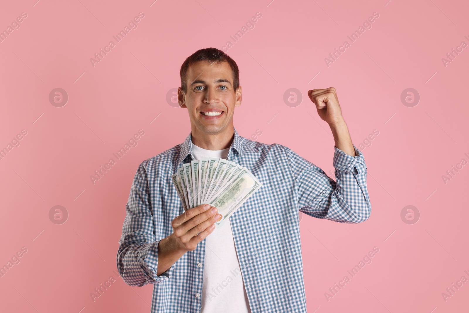 Photo of Happy man with money on pink background