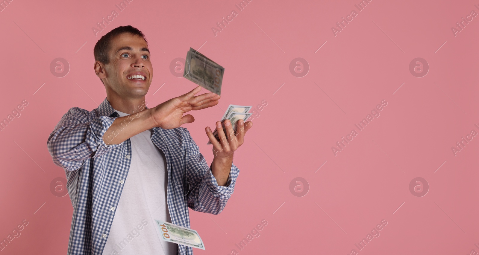 Photo of Man throwing money on pink background, space for text