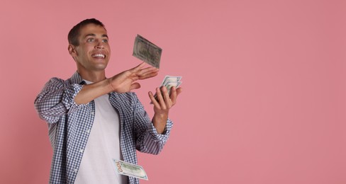 Man throwing money on pink background, space for text