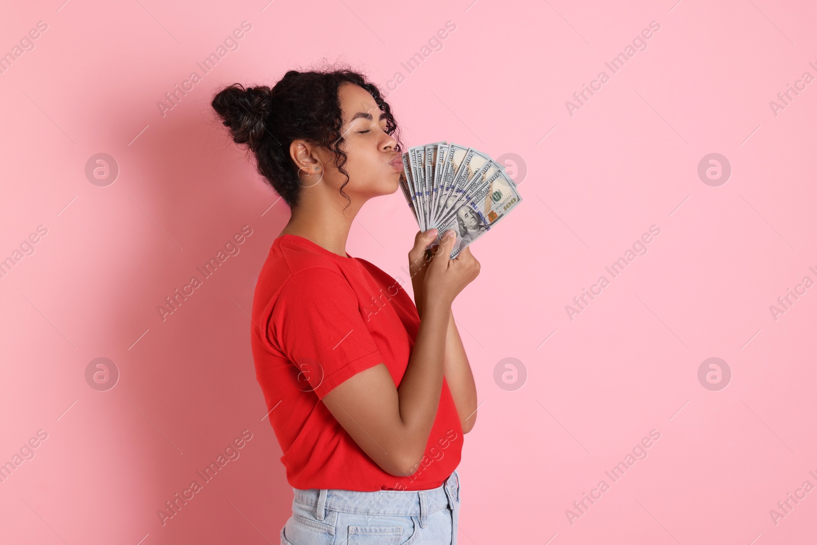 Photo of Woman with dollar banknotes on pink background