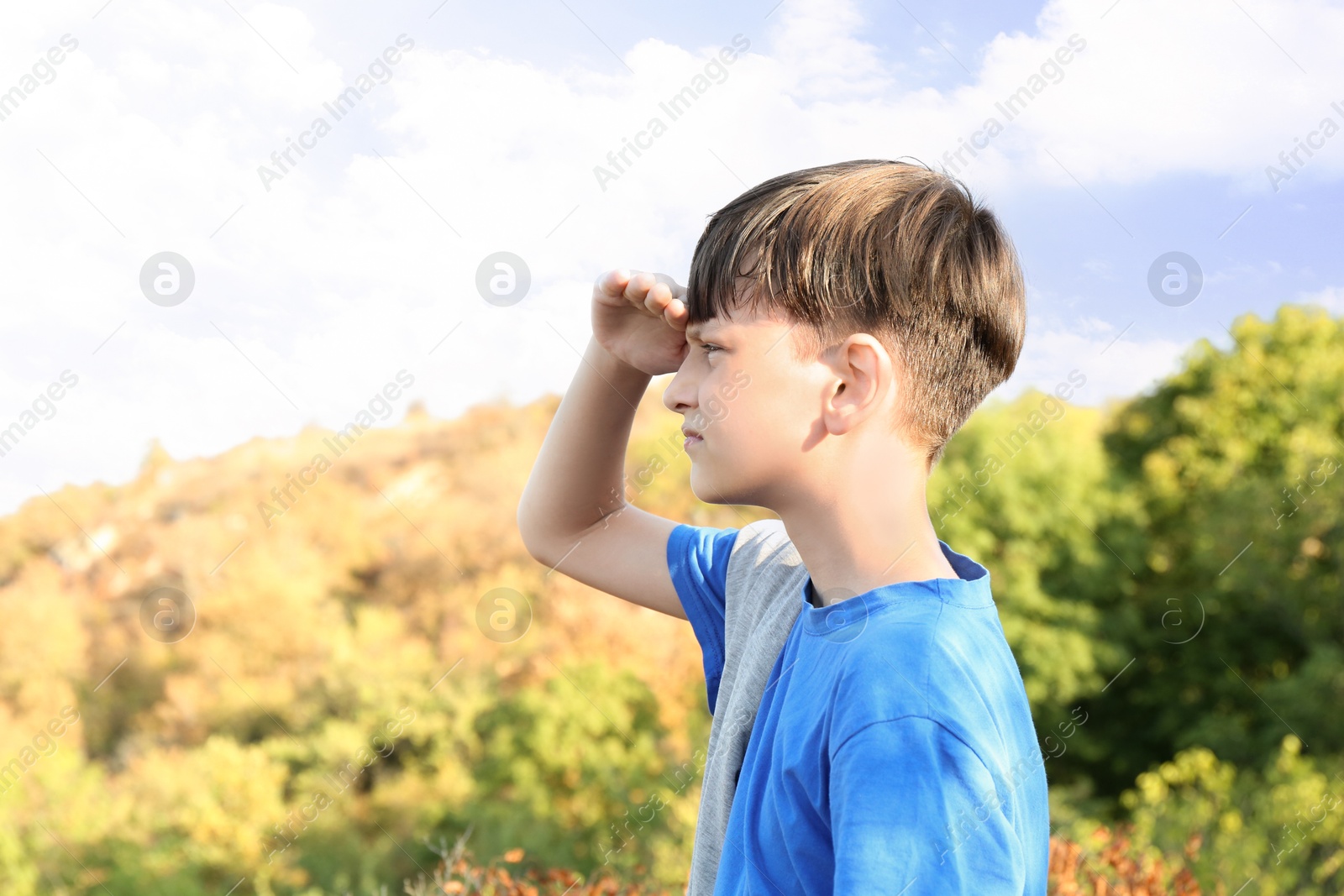 Photo of Little boy enjoying picturesque landscape. Space for text