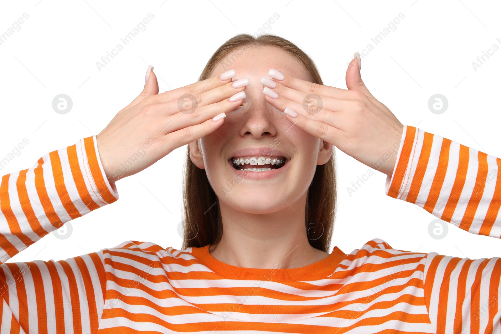 Photo of Smiling girl with braces covering eyes on white background