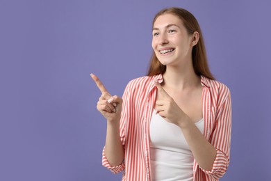 Photo of Smiling girl with braces on purple background, space for text