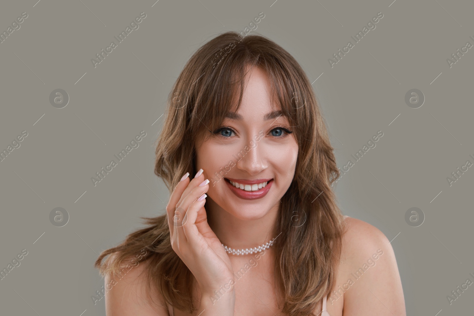 Photo of Attractive woman with stylish haircut on grey background